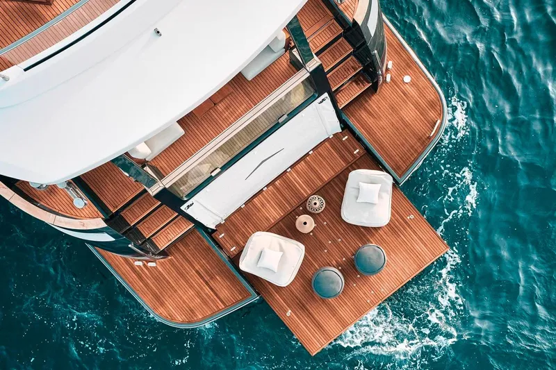 Yacht Photos Pics Aerial view of 2025 Azimut Magellano 25M yacht deck with seating area on blue water.