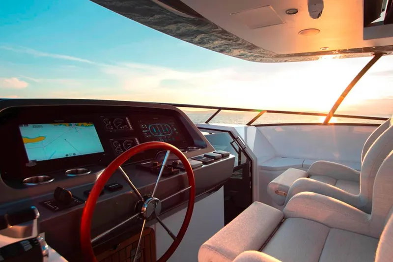  Yacht Photos Pics Luxurious helm of 2025 Azimut Magellano 25M yacht at sunset, featuring modern navigation controls.