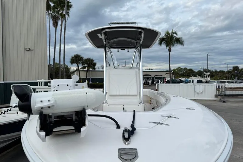  Yacht Photos Pics 2025 Contender 25 Tournament boat with T-top and trolling motor, docked under cloudy skies.