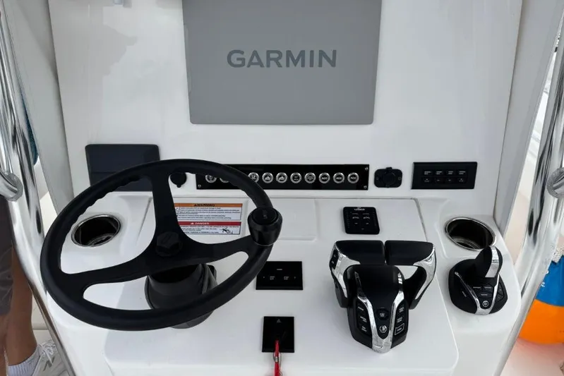  Yacht Photos Pics Steering console of 2025 Contender 25 Tournament boat with Garmin display and controls.