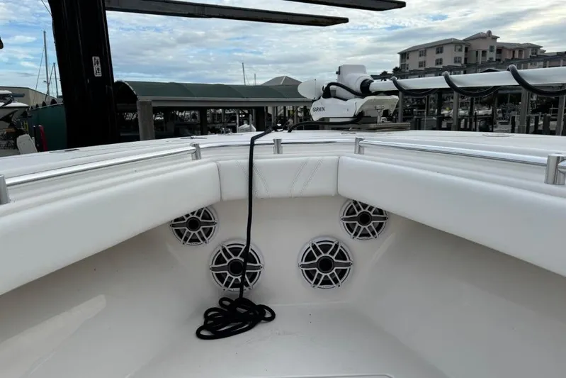  Yacht Photos Pics 2025 Contender 25 Tournament boat interior with speakers and railing, docked at marina.