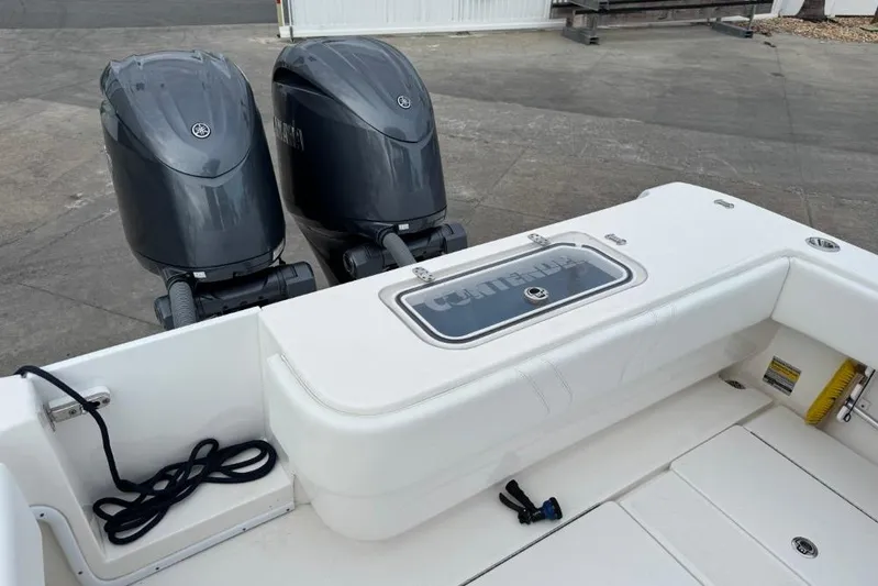  Yacht Photos Pics 2025 Contender 25 Tournament boat with dual outboard engines, white deck, and storage compartment.