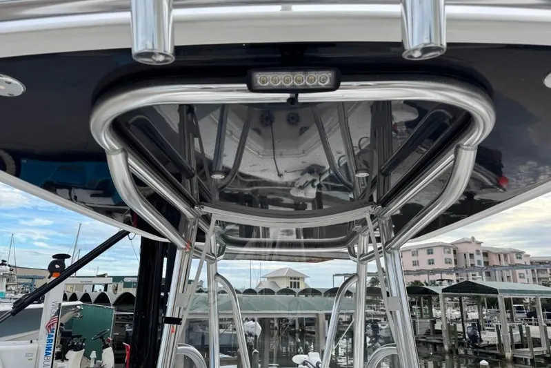  Yacht Photos Pics 2025 Contender 25 Tournament boat with sleek metal framework at marina.