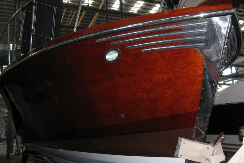 Miss Osb Yacht Photos Pics 2009 Hugh Saint 65 Commuter boat with polished wood finish in a warehouse setting.