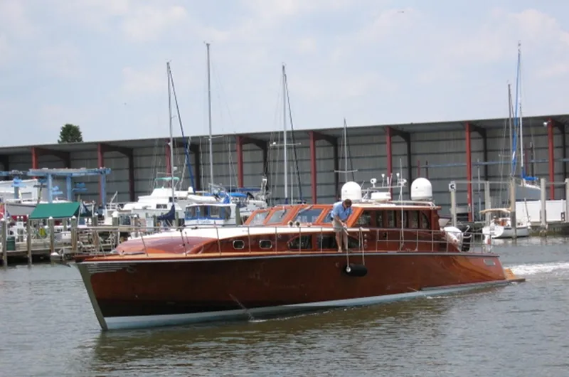 Miss Osb Yacht Photos Pics 2009 Hugh Saint 65 Commuter boat cruising near a marina with docked sailboats.
