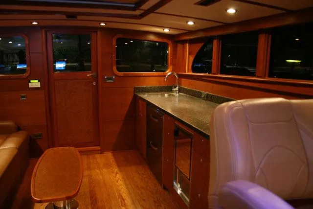 Miss Osb Yacht Photos Pics Luxurious interior of 2009 Hugh Saint 65 Commuter with wood finish and modern amenities.