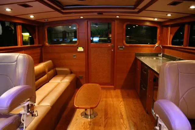 Miss Osb Yacht Photos Pics Luxurious interior of 2009 Hugh Saint 65 Commuter yacht with wood finishes and leather seating.