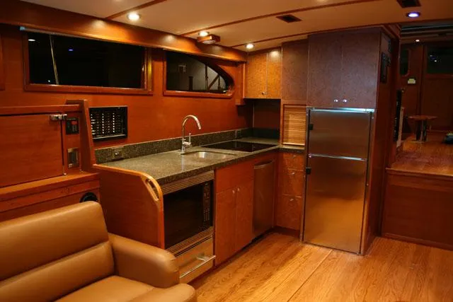 Miss Osb Yacht Photos Pics Luxurious 2009 Hugh Saint 65 Commuter yacht interior with modern kitchen and wooden finishes.