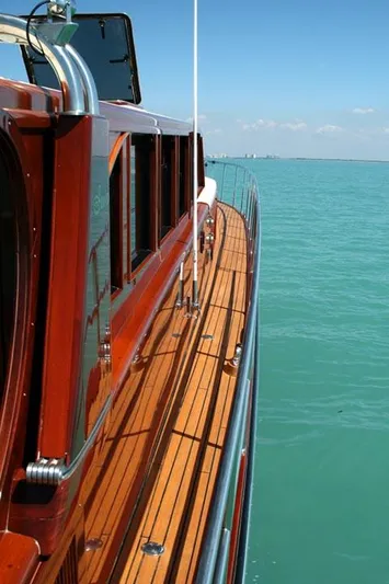 Miss Osb Yacht Photos Pics 2009 Hugh Saint 65 Commuter yacht with polished wood deck on calm blue water.