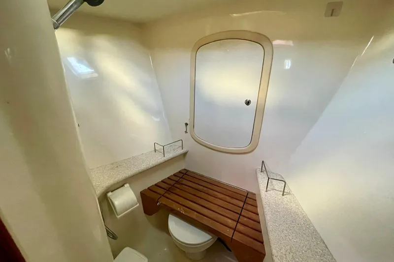  Yacht Photos Pics Bathroom interior of 2010 Hunter 45 Deck Salon yacht, featuring wooden bench and modern fixtures.