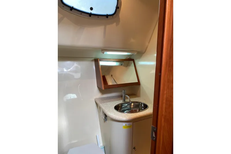  Yacht Photos Pics Compact bathroom in 2010 Hunter 45 Deck Salon yacht with sink and mirror.