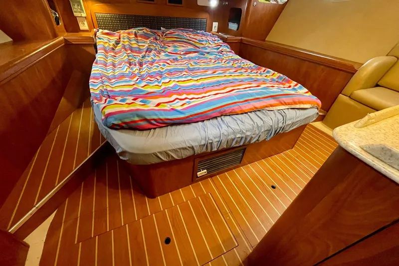  Yacht Photos Pics Cozy cabin interior of 2010 Hunter 45 Deck Salon with colorful bedding.