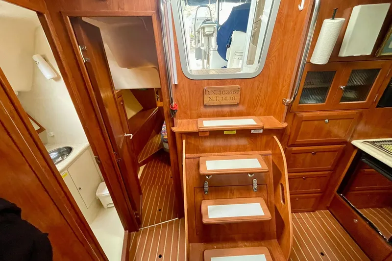  Yacht Photos Pics Interior of 2010 Hunter 45 Deck Salon yacht with wooden cabinetry and steps.