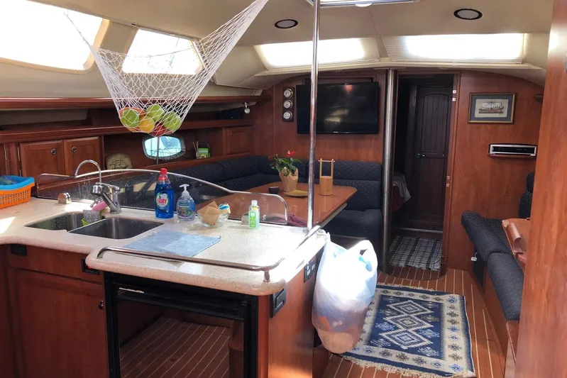  Yacht Photos Pics Interior of 2010 Hunter 45 Deck Salon yacht with kitchen and seating area.