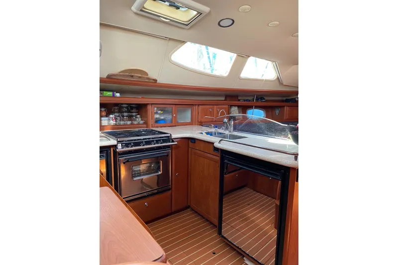  Yacht Photos Pics Interior of 2010 Hunter 45 Deck Salon yacht kitchen with stove and sink.