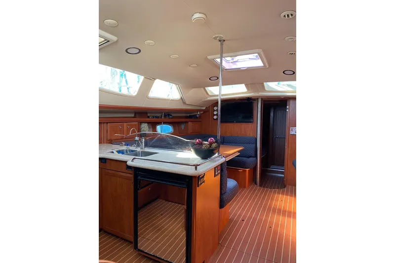  Yacht Photos Pics Interior of 2010 Hunter 45 Deck Salon yacht with modern kitchen and seating area.