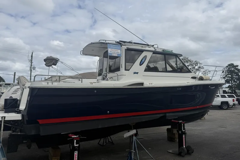  Yacht Photos Pics 2012 Cutwater C-28 boat on stands, blue hull, white cabin, overcast sky.