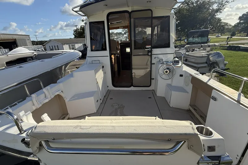  Yacht Photos Pics 2012 Cutwater C-28 boat interior with seating and steering wheel, docked outdoors.
