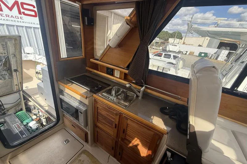  Yacht Photos Pics Interior of 2012 Cutwater C-28 boat with kitchenette and seating area.