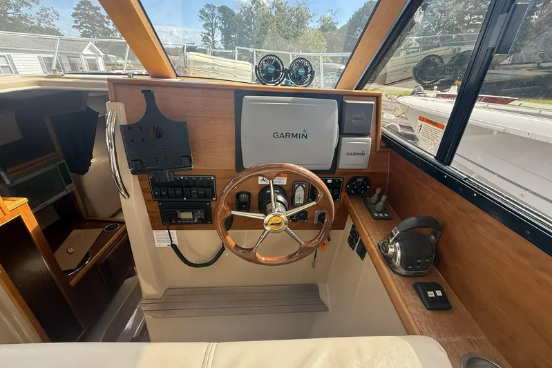  Yacht Photos Pics 2012 Cutwater C-28 helm with Garmin navigation, wooden steering wheel, and control panel.