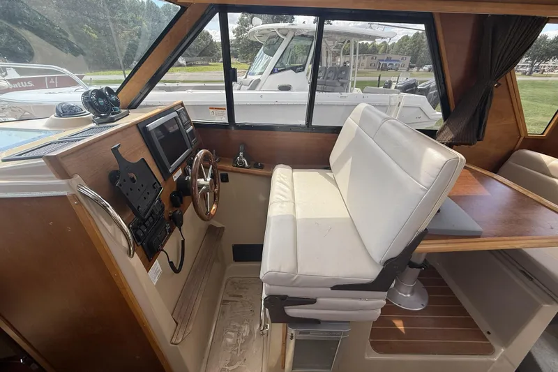  Yacht Photos Pics 2012 Cutwater C-28 boat interior with helm, steering wheel, and seating area.
