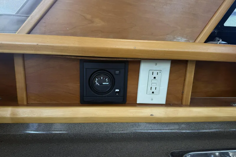  Yacht Photos Pics Wooden interior of 2012 Cutwater C-28 with water gauge and electrical outlet.