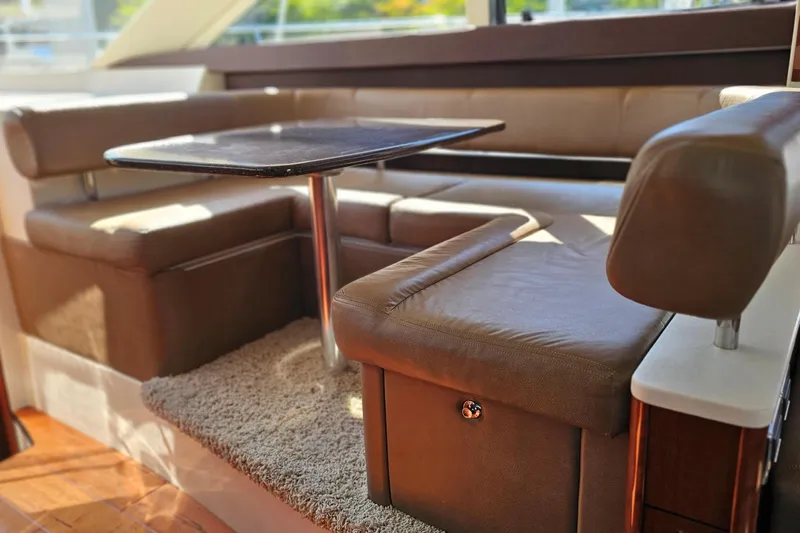  Yacht Photos Pics Luxurious interior seating area of a 2012 Meridian 441 yacht with a table.
