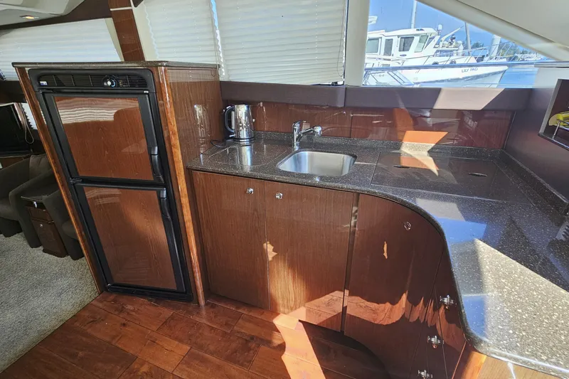  Yacht Photos Pics Luxurious 2012 Meridian 441 yacht kitchen with sleek wood cabinetry and modern appliances.