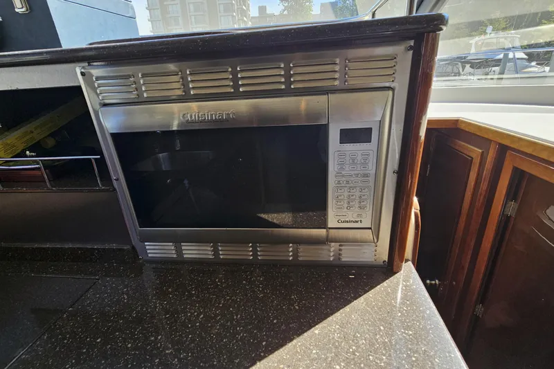  Yacht Photos Pics Cuisinart microwave in 2012 Meridian 441 yacht kitchen, featuring sleek design and modern cabinetry.