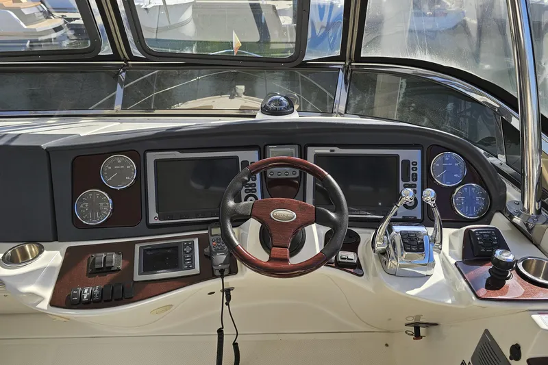  Yacht Photos Pics Cockpit of 2012 Meridian 441 yacht with steering wheel and navigation controls.