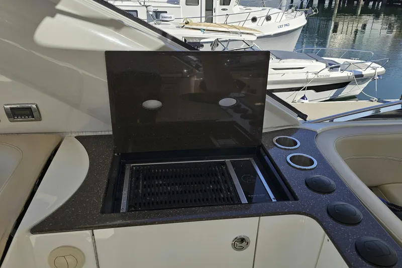  Yacht Photos Pics Outdoor grill on 2012 Meridian 441 yacht, docked with boats in the background.