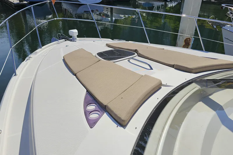  Yacht Photos Pics 2012 Meridian 441 yacht with sunbathing cushions on deck, docked in marina.