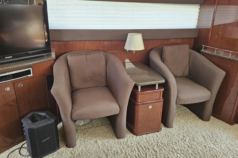  Yacht Photos Pics Interior of 2012 Meridian 441 yacht with chairs, table, and entertainment setup.