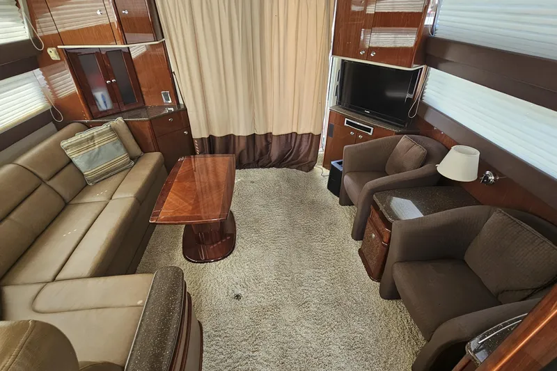  Yacht Photos Pics Luxurious interior of 2012 Meridian 441 yacht with plush seating and elegant wood finishes.