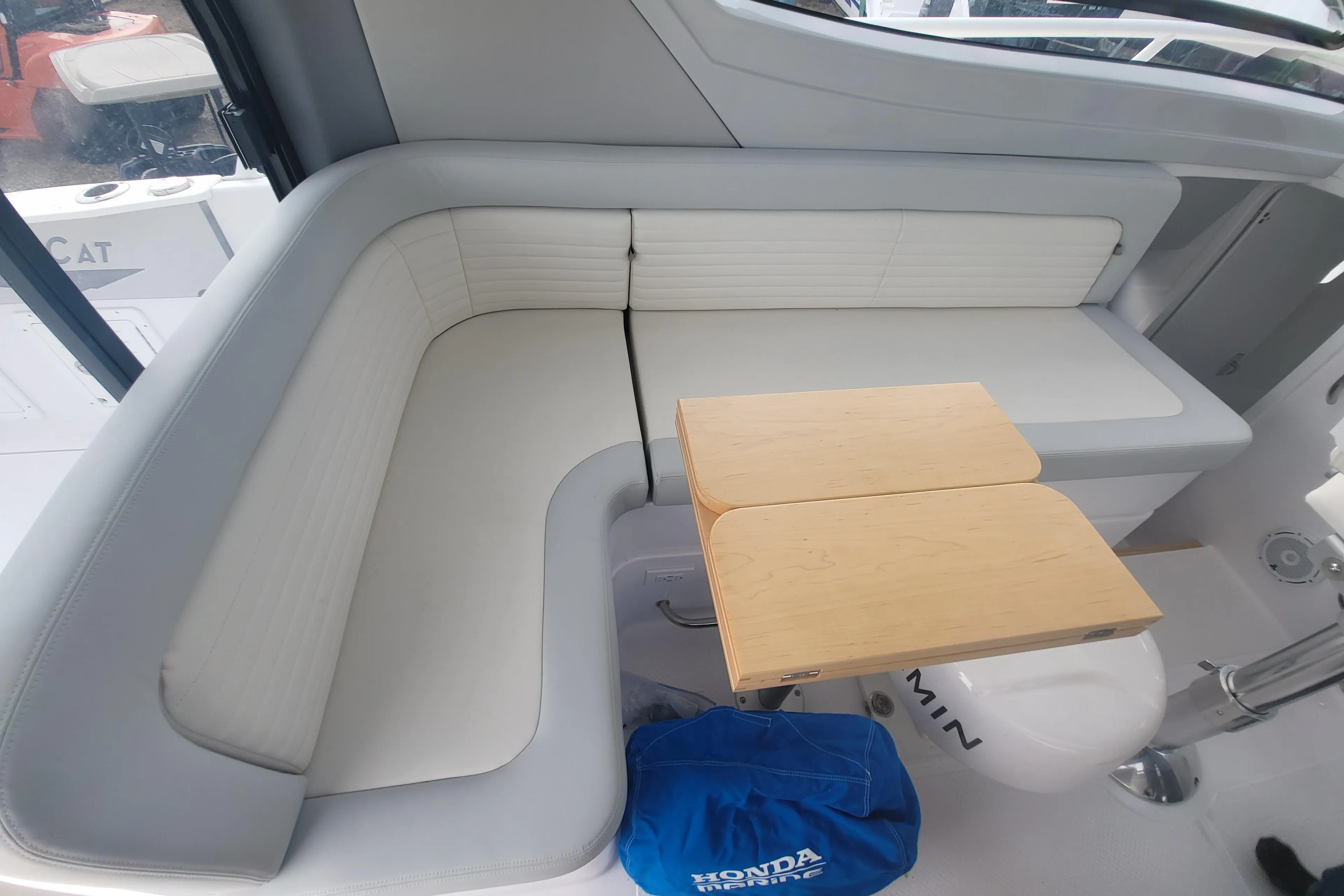 Interior seating area of 2024 ArrowCat 320 with foldable table.