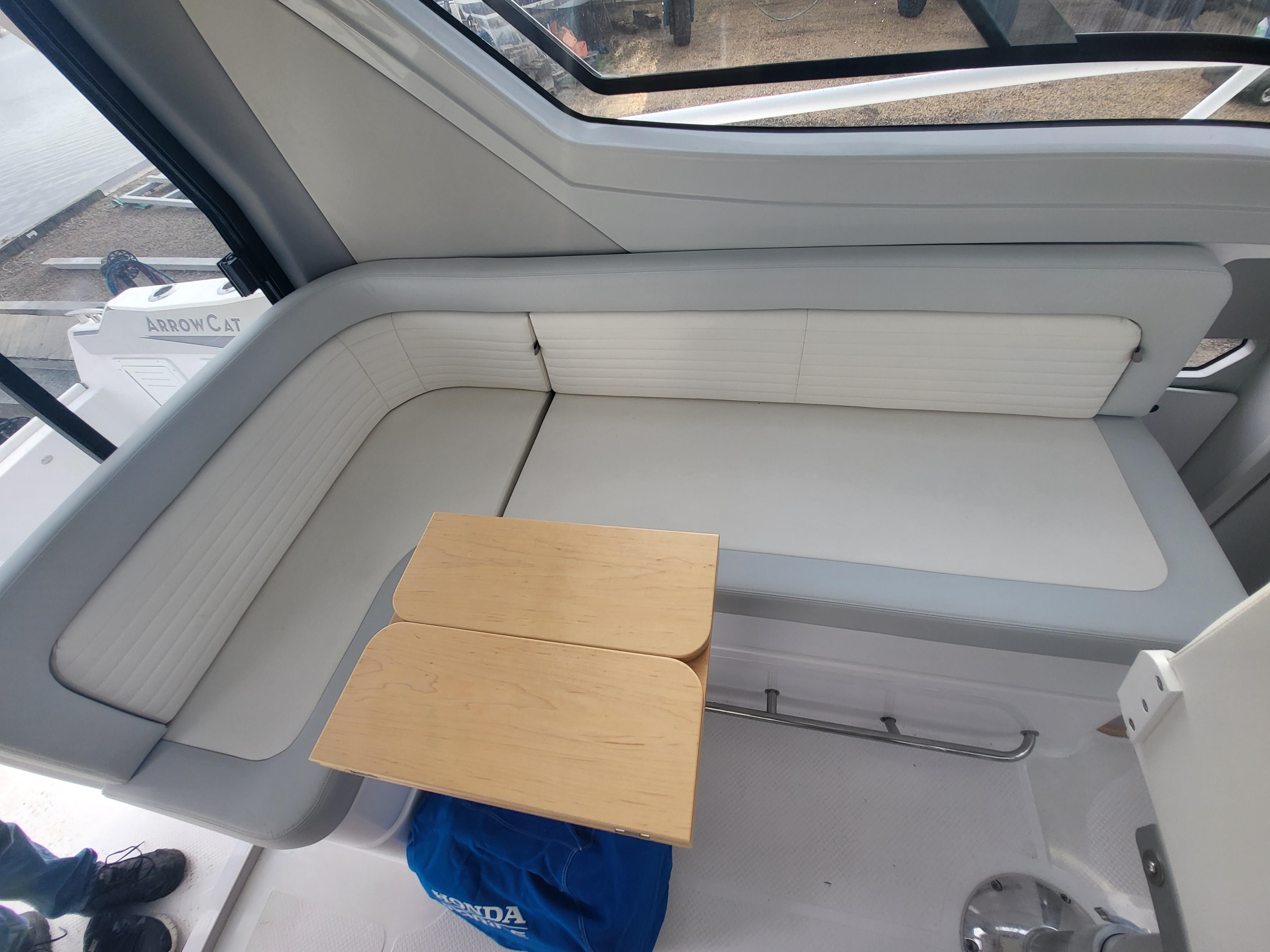 2024 ArrowCat 320 interior seating area with a small wooden table.