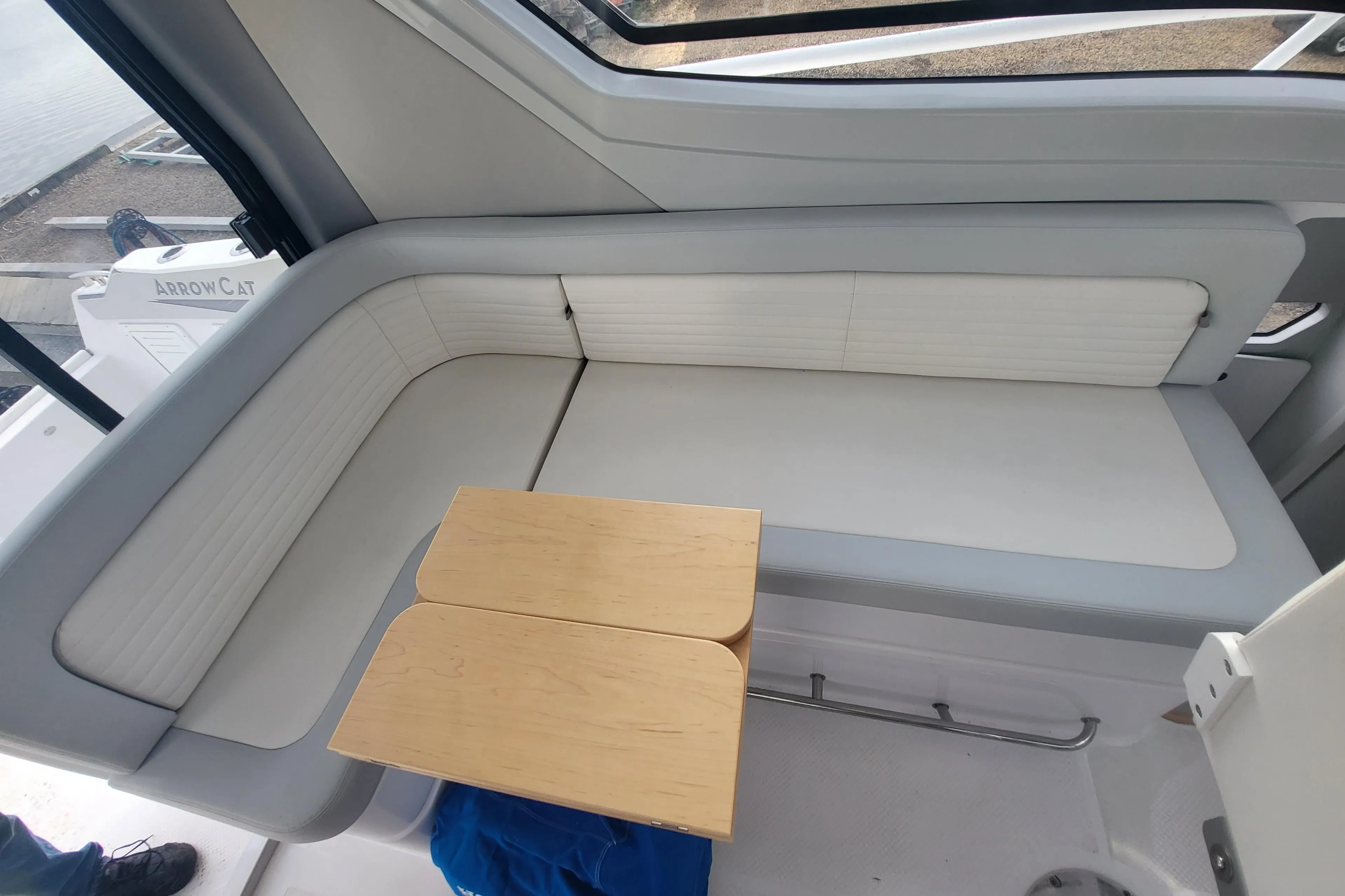 2024 ArrowCat 320 interior seating area with a small wooden table.