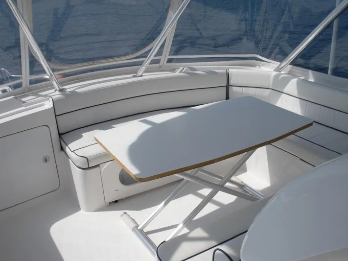  Yacht Photos Pics 2005 Bertram 510 yacht interior with white seating and table.