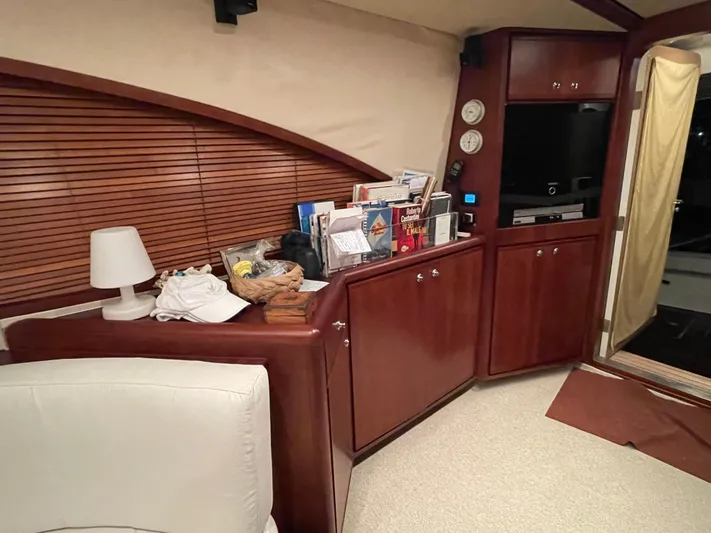  Yacht Photos Pics Interior of a 2005 Bertram 510 yacht with wooden cabinets and a cozy seating area.