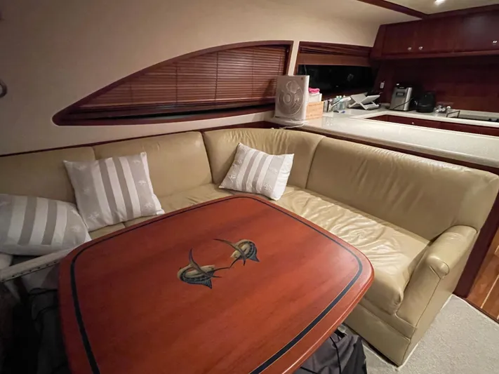  Yacht Photos Pics Luxurious 2005 Bertram 510 yacht interior with leather seating and elegant wooden table.