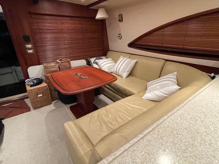  Yacht Photos Pics Luxurious interior of a 2005 Bertram 510 yacht with leather seating and wooden table.