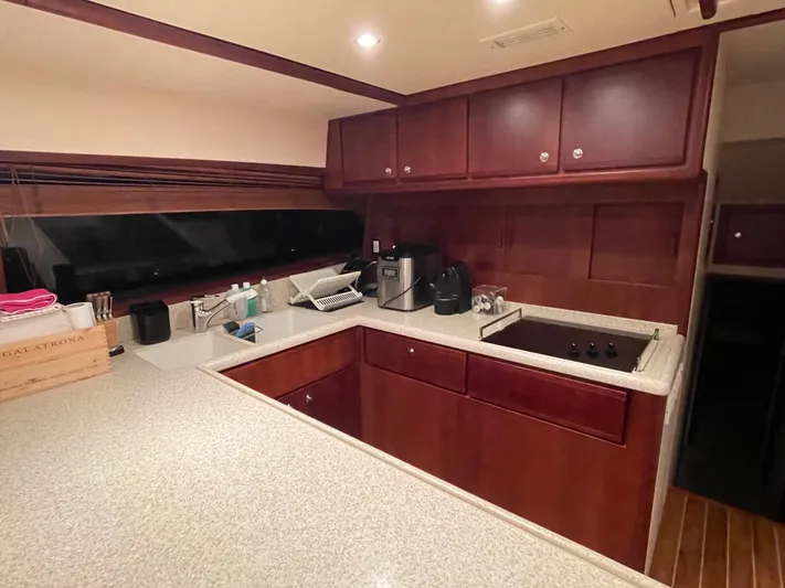  Yacht Photos Pics 2005 Bertram 510 yacht kitchen with wooden cabinets and modern appliances.