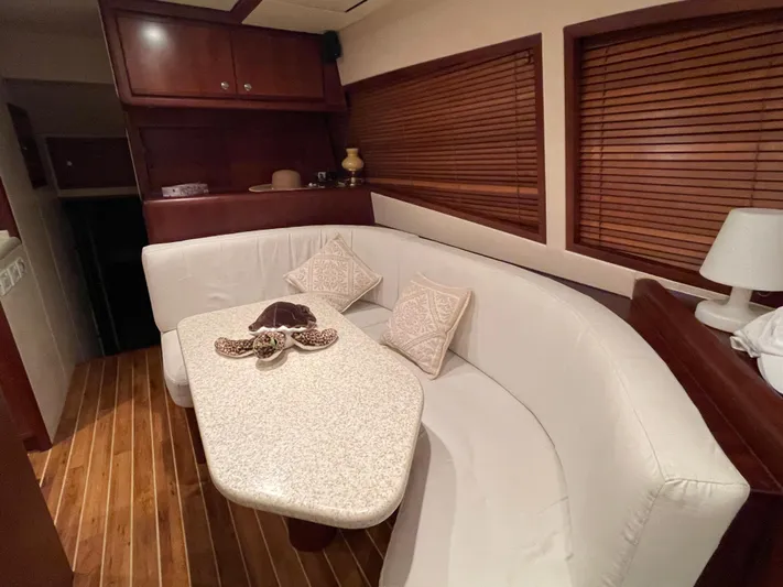  Yacht Photos Pics Luxurious 2005 Bertram 510 yacht interior with elegant dining area and wooden accents.