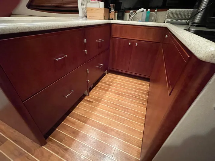  Yacht Photos Pics Luxurious wooden cabinetry in a 2005 Bertram 510 yacht kitchen interior.