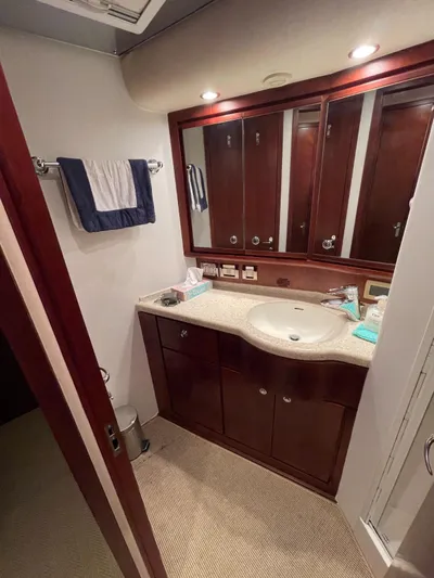  Yacht Photos Pics Luxurious bathroom in 2005 Bertram 510 yacht with elegant wood cabinetry and modern fixtures.
