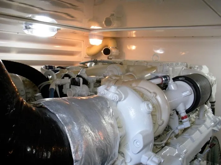  Yacht Photos Pics Engine room of a 2005 Bertram 510 yacht, showcasing mechanical components and piping.