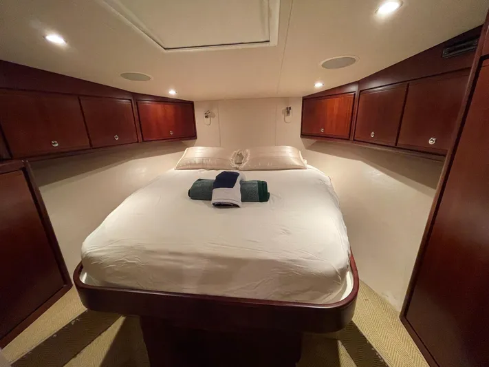  Yacht Photos Pics Luxurious cabin interior of a 2005 Bertram 510 yacht with cozy bedding.