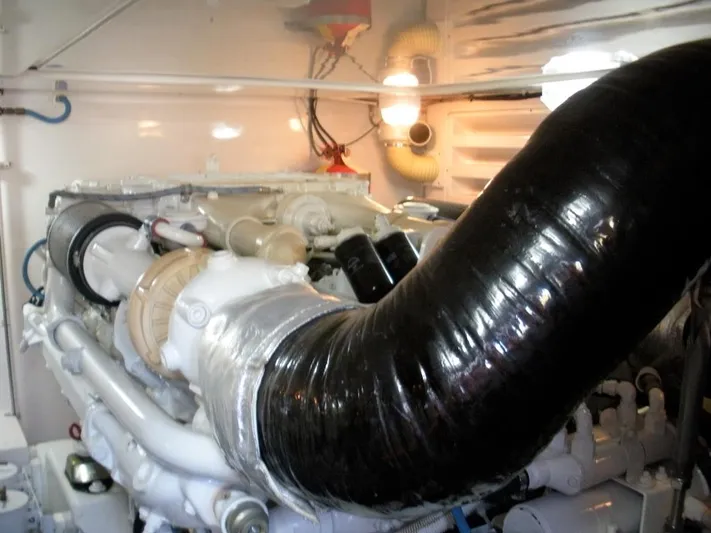  Yacht Photos Pics Engine compartment of a 2005 Bertram 510 yacht, featuring a large black exhaust hose.