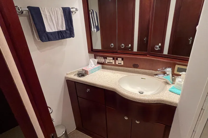  Yacht Photos Pics Luxurious bathroom in a 2005 Bertram 510 yacht with elegant wood cabinetry.