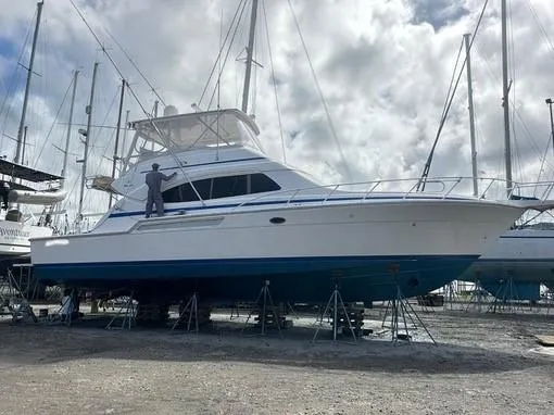  Yacht Photos Pics 2005 Bertram 510 yacht on stands, cloudy sky background.